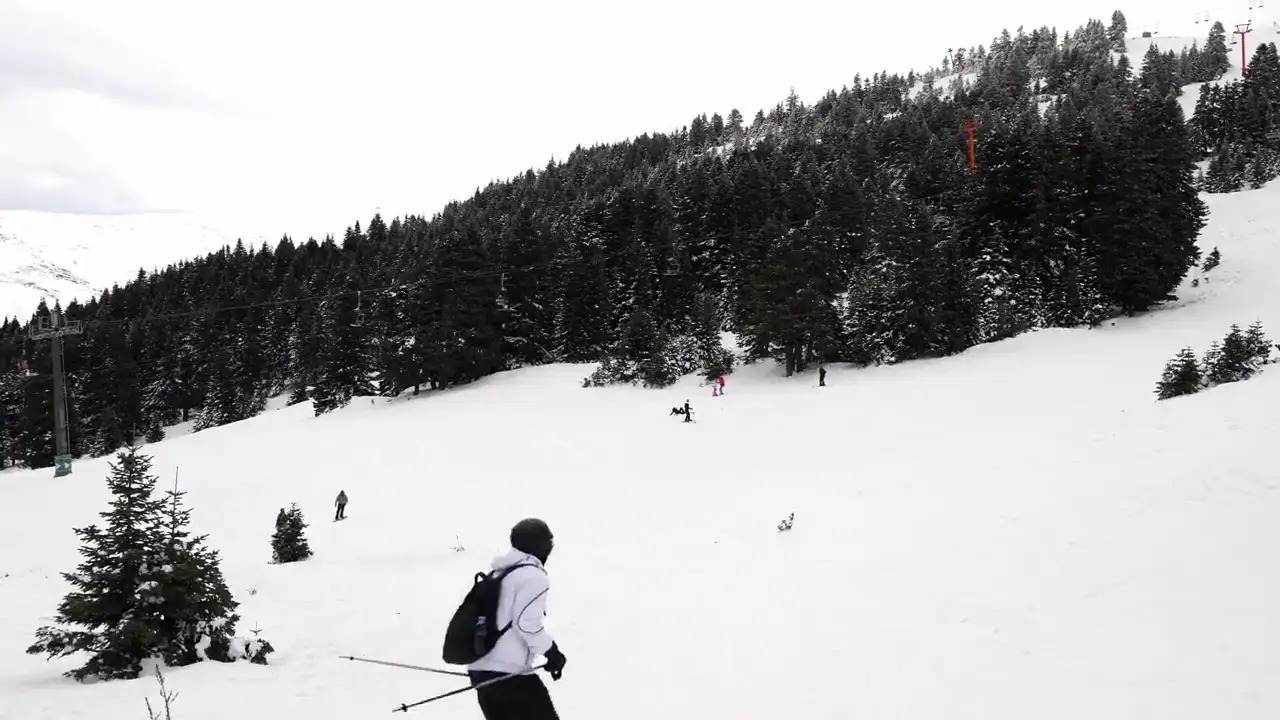 Skifahrer auf einer verschneiten Piste in den Alpen